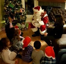 Santa having a chat with his young friends.