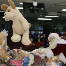 Santa catching a stuffed bear for CHEO