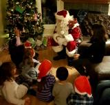 Santa having a chat with his young friends.